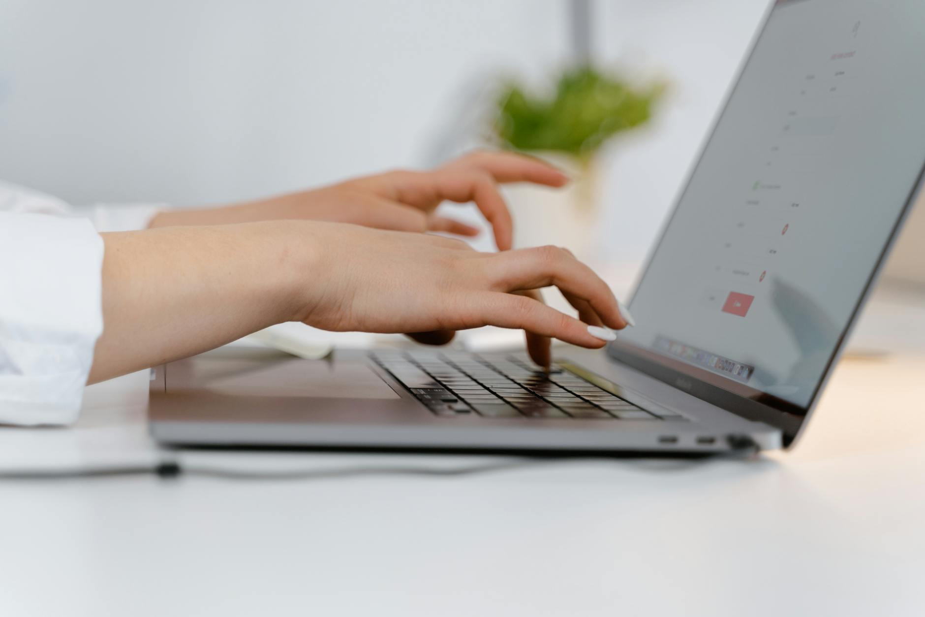 a person typing on a laptop