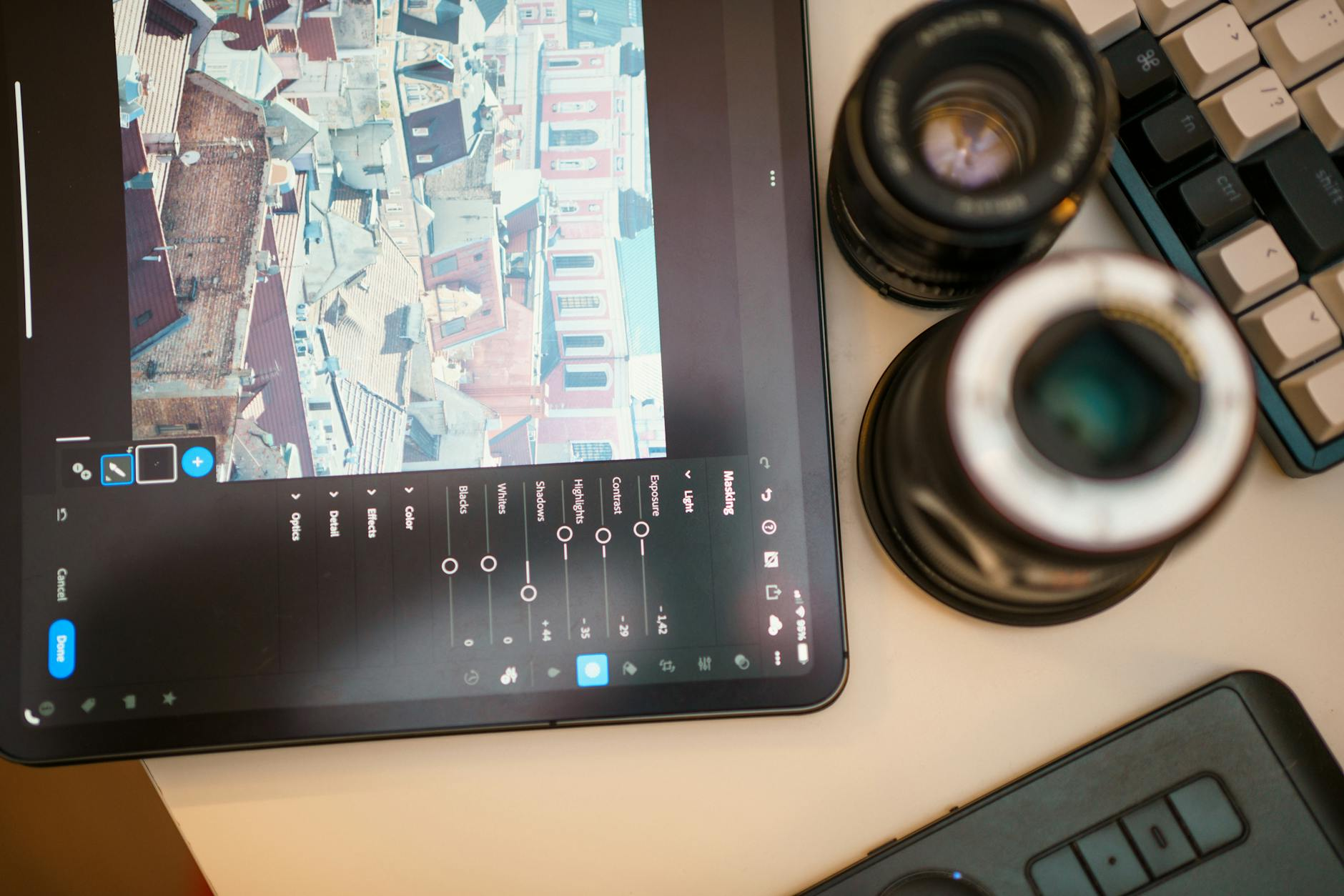 digital photo editing workspace with tablet and lens